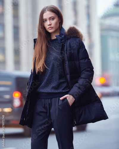 Young beautiful blonde model in fashionable clothes on the street. Street modern womens fashion