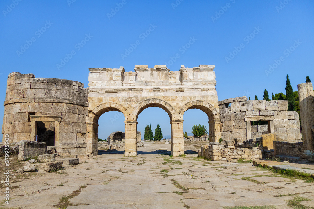Domitian gates & its towers on Frontinus street of antique city Hierapolis, Pamukkale, Turkey. Built in honor of emperor. Travertine was used for some decorative elements. Now included in UNESCO List
