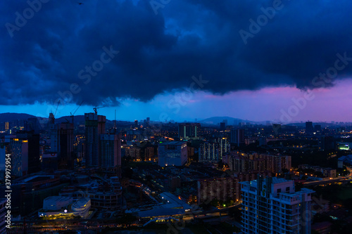 Evening city sunset with rain clouds. Night rain. Gorgeous views of the landscapes of Kuala Lumpur