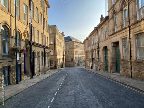 Fototapeta Naklejka Na Ścianę i Meble -  Currer Street, in the heart of former textile buildings, built with Yorkshire stone in, Little Germany, Bradford, UK