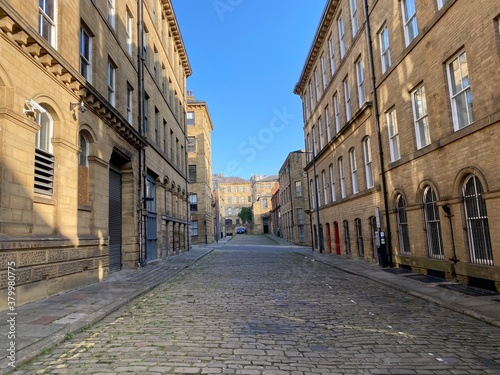 Looking along, Cater Street, at former textile buildings, built with Yorkshire stone in, Little Germany, Bradford, UK © derek oldfield