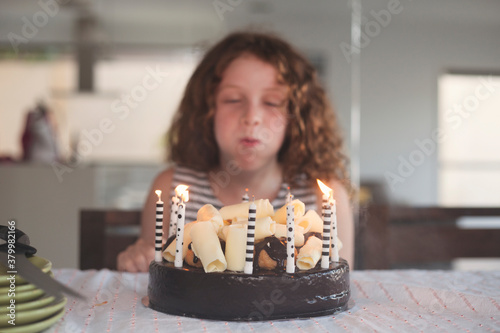 girl blowing out birthday candles photo