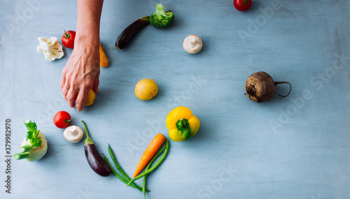 Hand arranging vegetables in heart shape