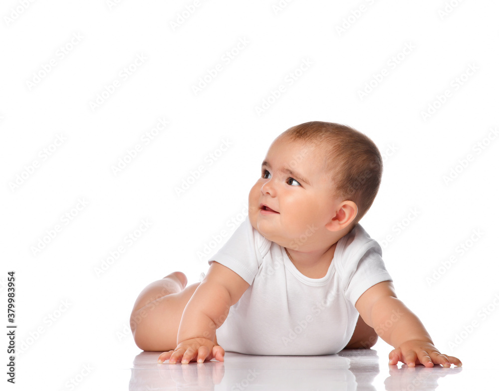 Smiling baby kid creeping on white studio floor Smiling baby kid creeping on white studio floor