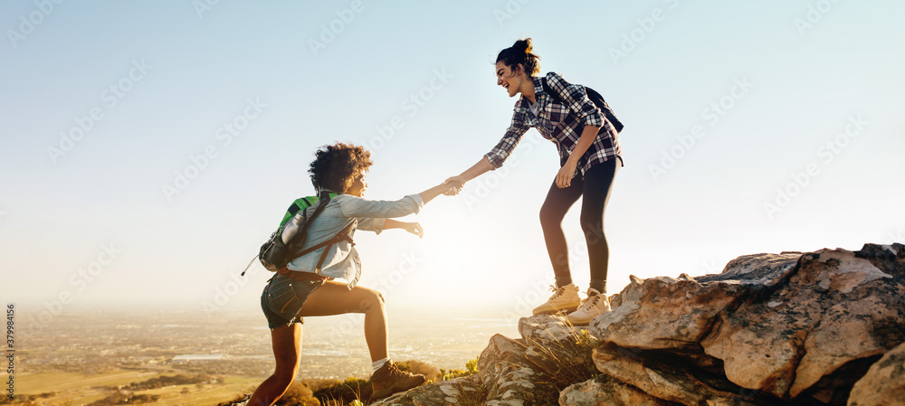 Helping each other to the top of mountain - obrazy, fototapety, plakaty 