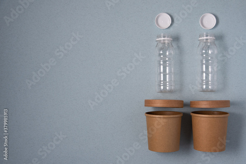 Vászonkép plastic and paper tableware for takeaway on a blue background in the top view