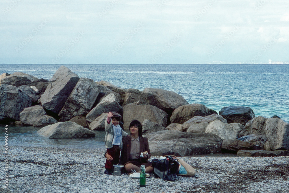 1981. Mom and son having a picnic on the beach 1981. Mom and son having a picnic on the beach