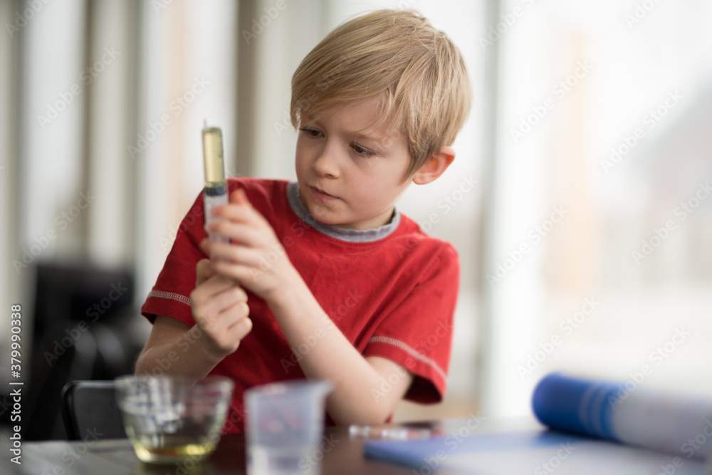 Little Boy Scientist Measuring WIth Chemistry Set for Science Education Little Boy Scientist Measuring WIth Chemistry Set for Science Education