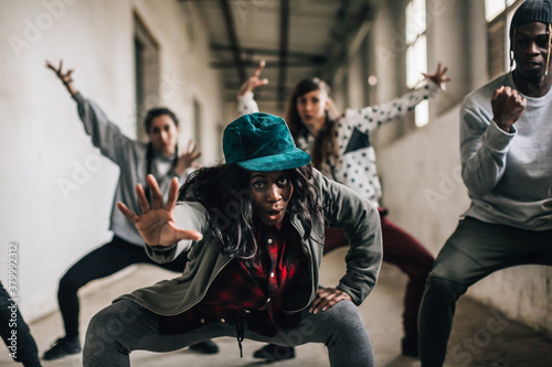 Hip hop team dancing in an old factory. photo