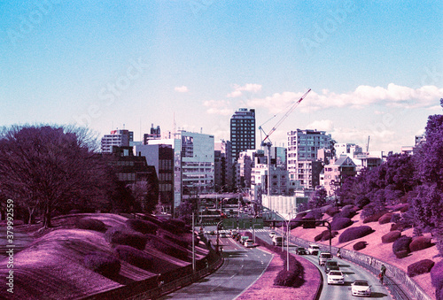 Road leading to city skyscrapers in the distance photo