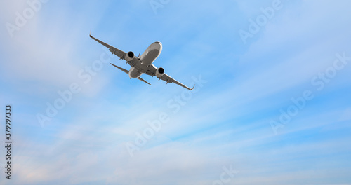 White passenger airplane in the clouds - Travel by air transport