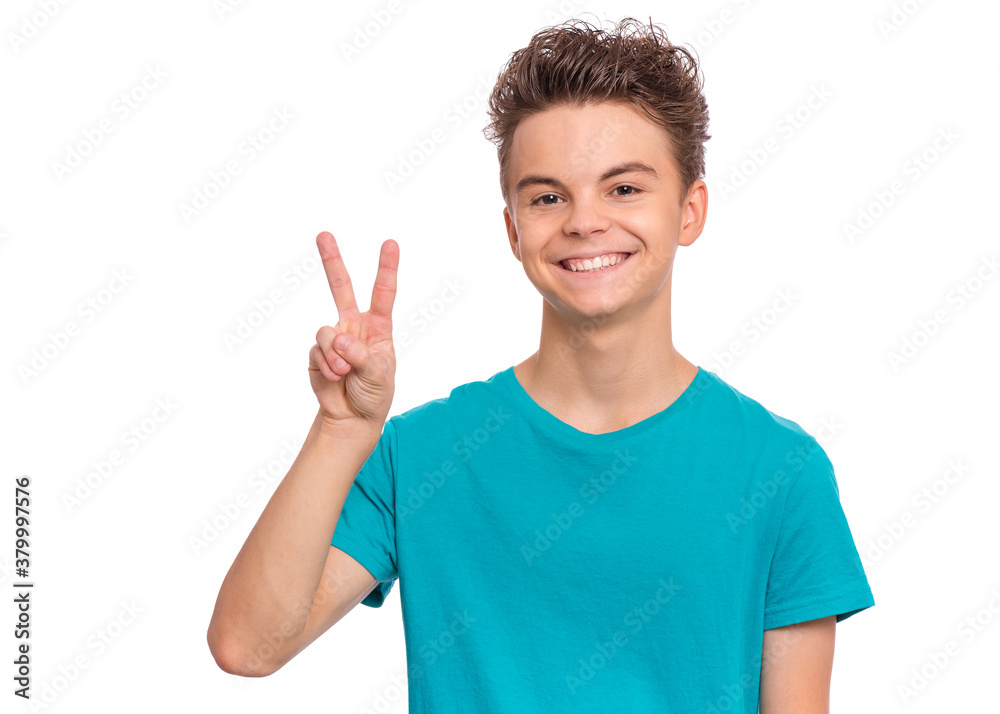 Portrait of handsome teen boy making Victory Gesture. Happy cute child isolated on white background. Portrait of handsome teen boy making Victory Gesture. Happy cute child isolated on white background.