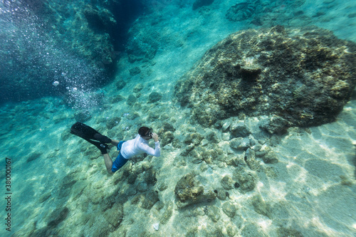 Free diver underwater equalizing ear pressure at the depth