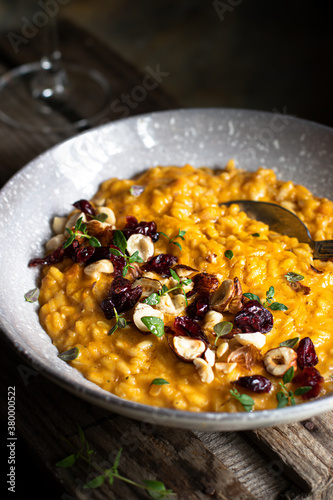 Obraz w ramie Pumpkin risotto with hazelnuts and cranberries 