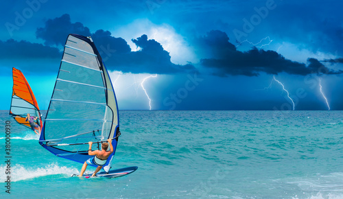 Windsurfer Surfing The Wind On Waves with strom and lightning - In Alacati, Cesme, Turkey 