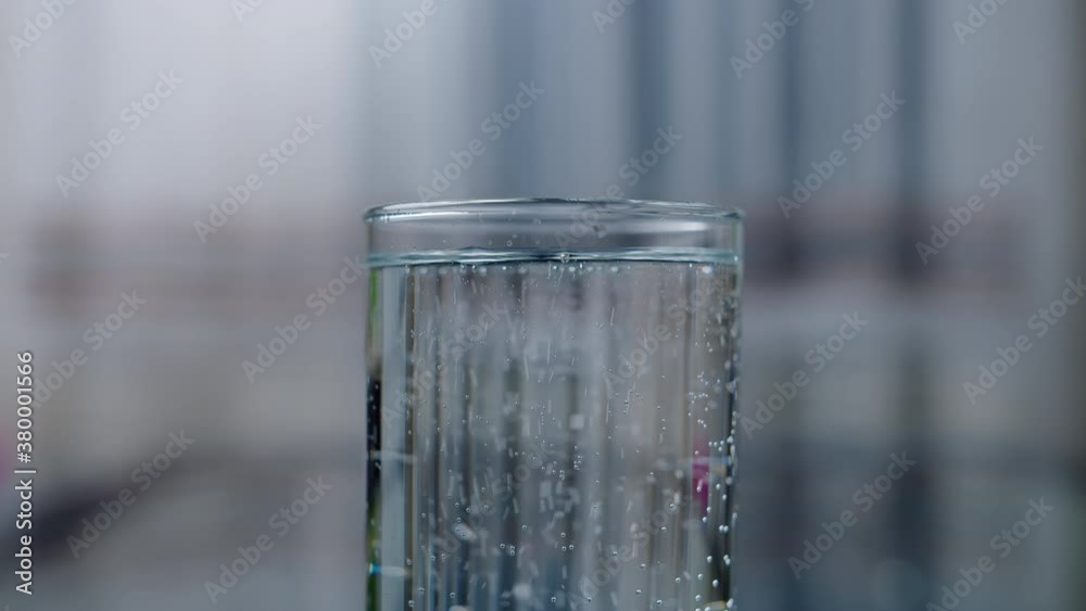 Close-up of a glass with clean drinking water, camera movement Close-up of a glass with clean drinking water, camera movement
