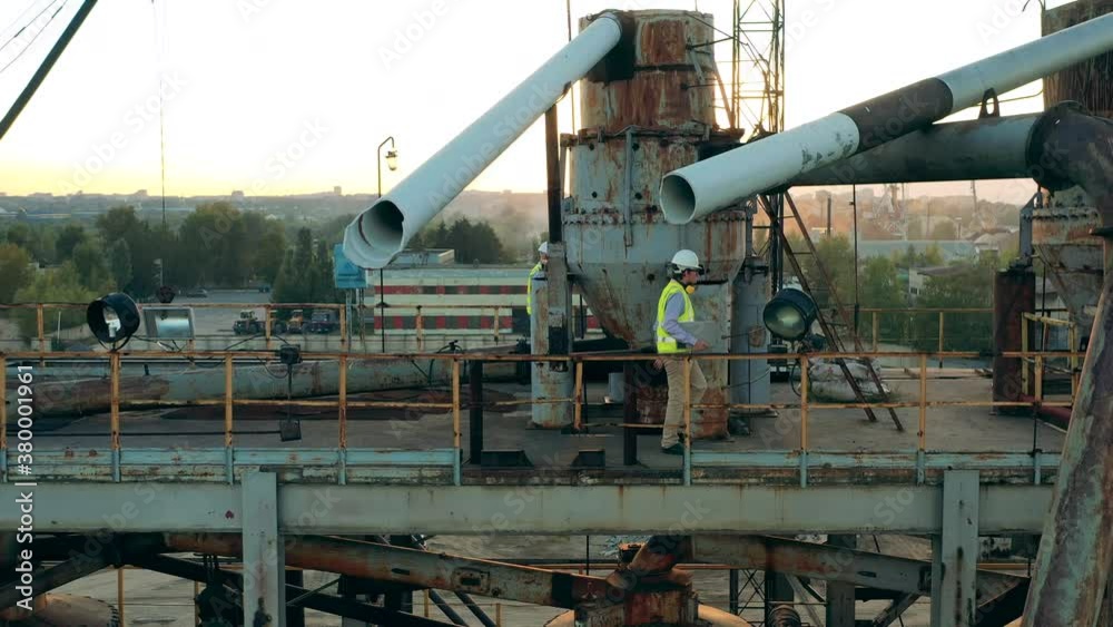 Engineers are walking along the construction platform in the quarry Engineers are walking along the construction platform in the quarry