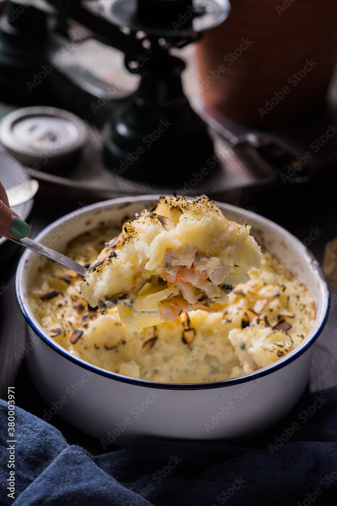 A serving of fish pie on a large serving spoon. A serving of fish pie on a large serving spoon.