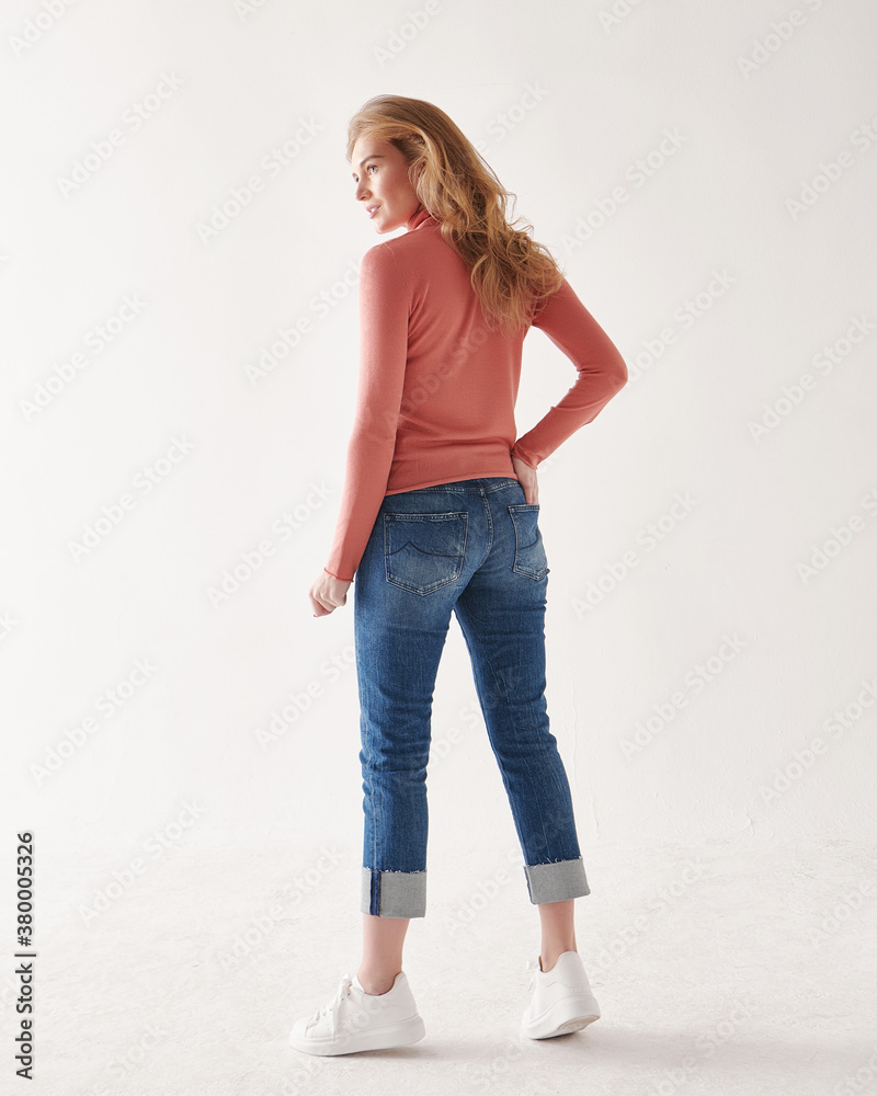Young beautiful fashionable model posing in casual clothes in the studio.