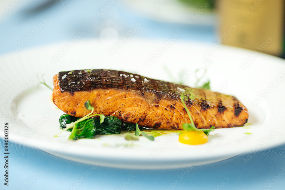 Grilled salmon fillet steak on the blue table Grilled salmon fillet steak on the blue table