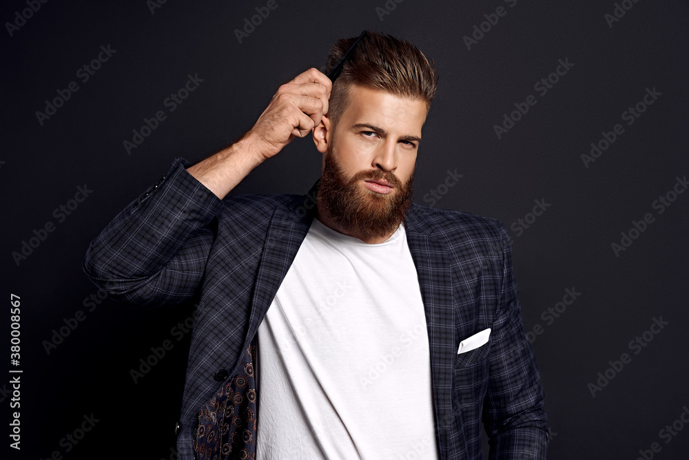 Photo of amazing macho take care hairdo after barber shop wear casual white t-shirt and jacket isolated on black background