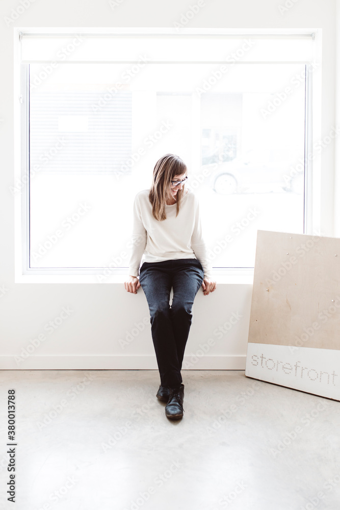 Small business owner sitting in empty storefront Small business owner sitting in empty storefront