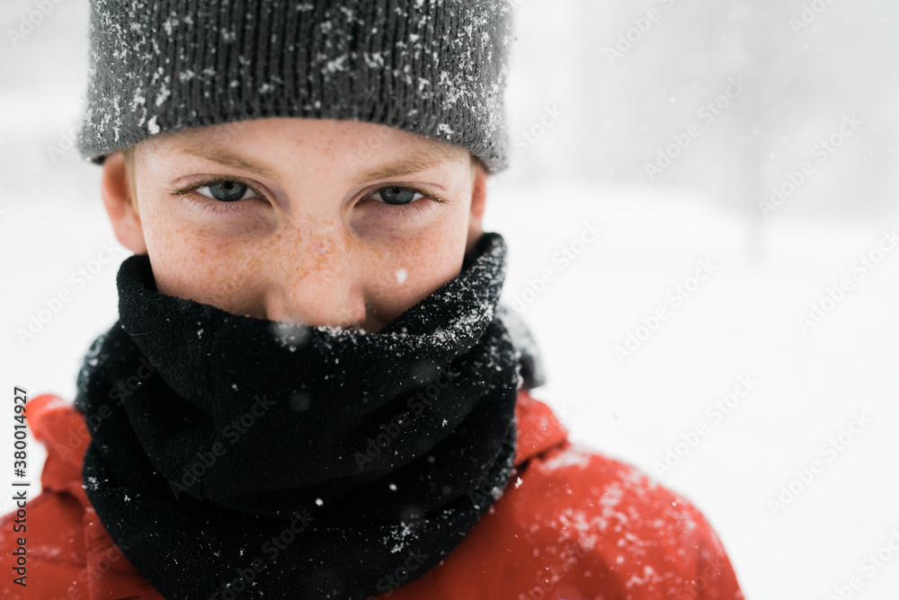 boy in snow with cowl and hat boy in snow with cowl and hat