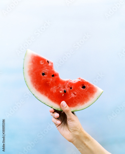 Person holding bite watermelon photo