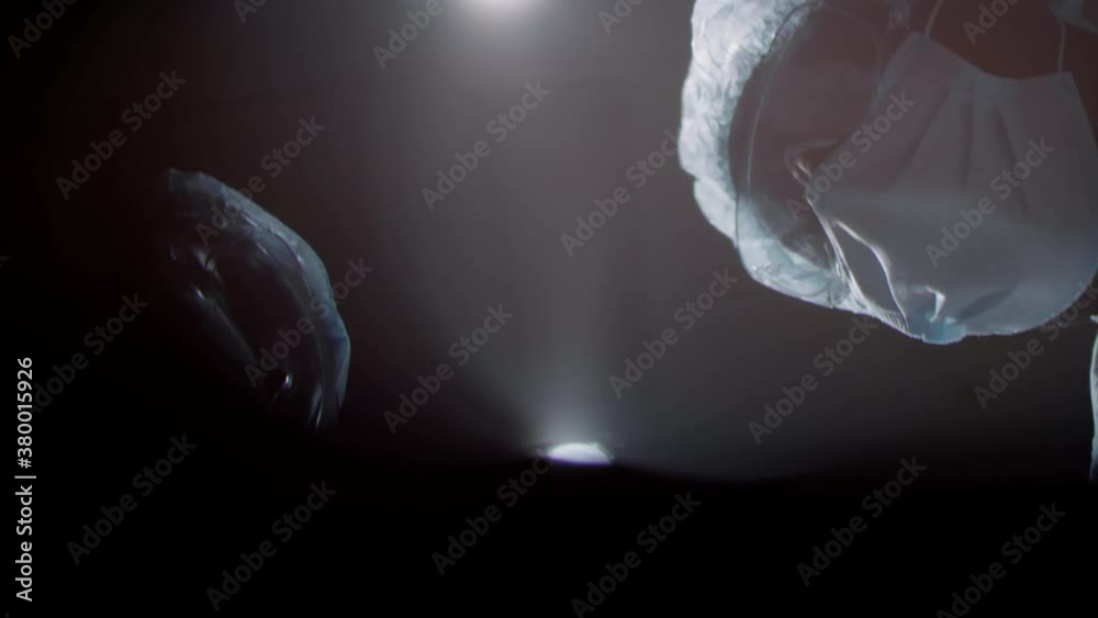 From below point of view shot of unrecognizable professional surgeons starting doing surgery for patient
