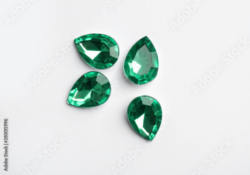 Beautiful gemstones on white background, top view photo