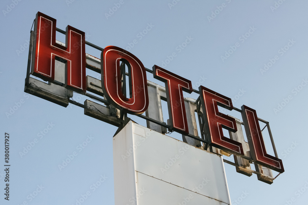 Red Letters Of A Hotel Sign At Daylight. Red Letters Of A Hotel Sign At Daylight.