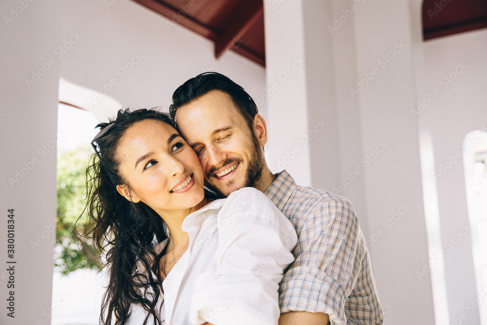 Smiling Couple Stand in Open Doorway
