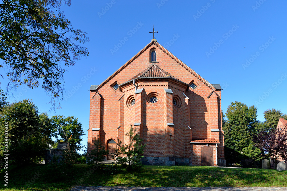 built in 1864 in the neo-Gothic style, the Catholic church dedicated to the elevation of the Holy Cross in the town of Ukta in warmia and Masuria in Poland in the photos along with a wooden belfry
