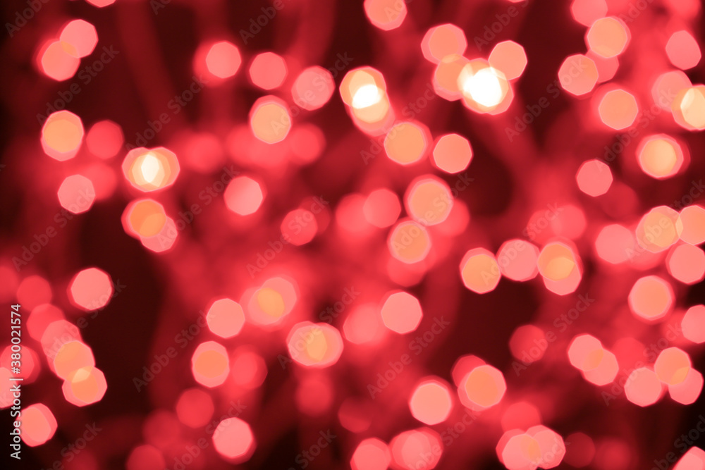 Christmas and Happy New Year on blurred red bokeh on black background, glowing sparks, holiday lights, valentine's day, place for text Christmas and Happy New Year on blurred red bokeh on black background, glowing sparks, holiday lights, valentine's day, place for text