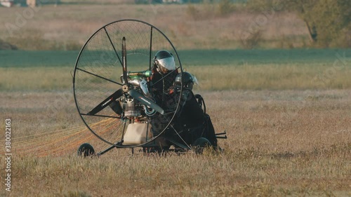 Preparation for take off, tandem paramotorgliding, slow motion, wide shot. High quality 4k footage photo