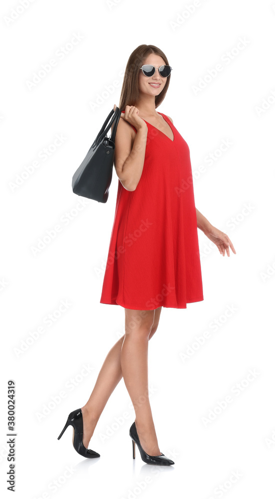 Young woman wearing stylish red dress with elegant bag on white background Young woman wearing stylish red dress with elegant bag on white background