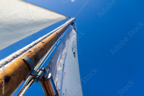 Sailing mast reaching towards blue sky