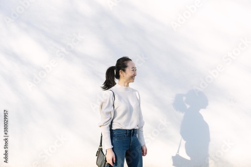 Asian girl with pony tail smiling on white background photo