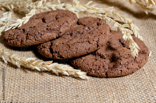 Three chocolate oatmeal cookies on a napkin homemade baking concept and as an advertisement