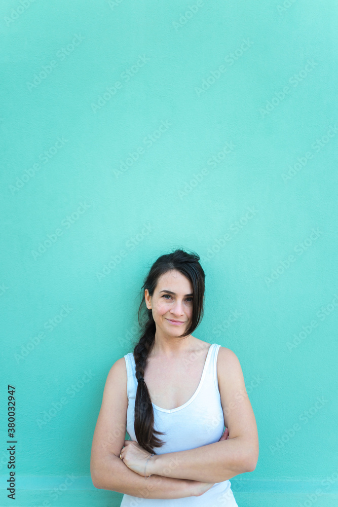 Portrait of a brunette woman with a braid against a colored background Portrait of a brunette woman with a braid against a colored background