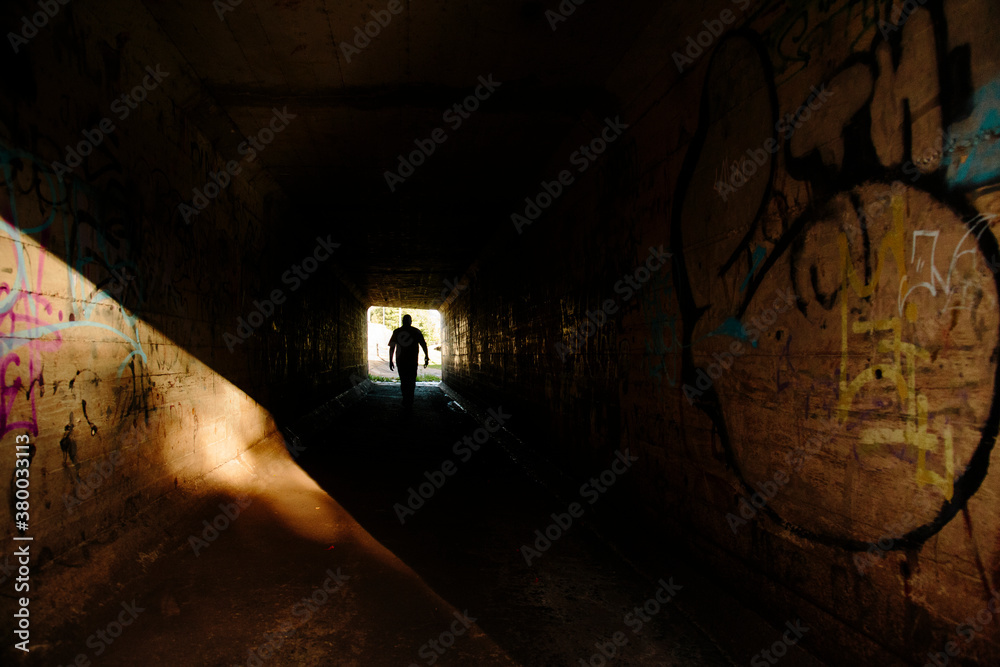 Silhouette of a man in a tunnel Silhouette of a man in a tunnel