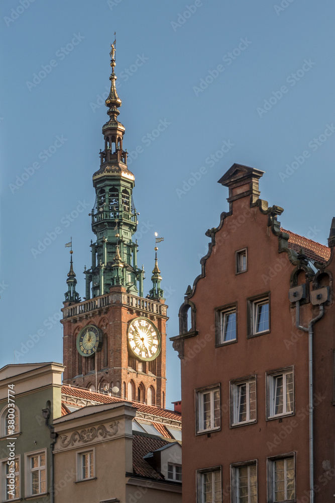 Tower of the townhall in Gdansk, Poland behind historic houses Tower of the townhall in Gdansk, Poland behind historic houses
