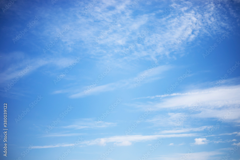 Blue sky background and white clouds soft focus, and copy space