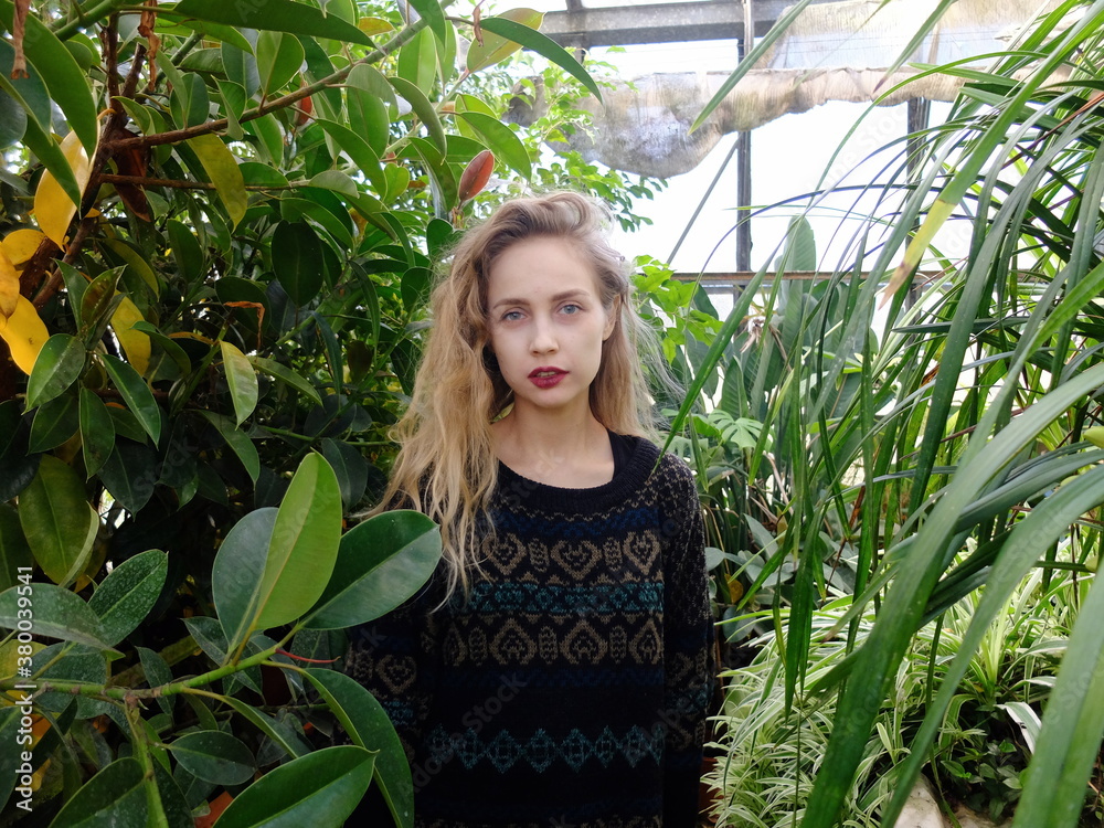 A beautiful woman in a greenhouse