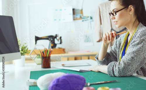 Portrait of Fashion designer working in her studio