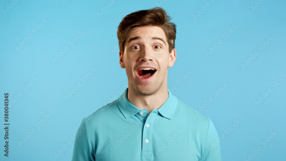 Amazed european man shocked, saying WOW. Handsome guy surprised to camera over blue background. Amazed european man shocked, saying WOW. Handsome guy surprised to camera over blue background.