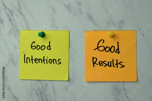 Фотография Good Intentions or Good Results write on sticky note isolated on Office Desk