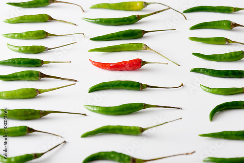 Arrangement of Green and One Red Chilli Peppers photo