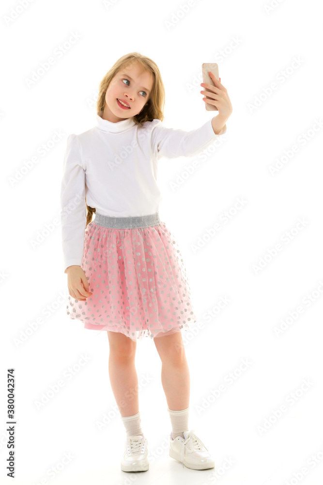 Fototapeta premium The girl is using a cell phone.The concept of people and technology.