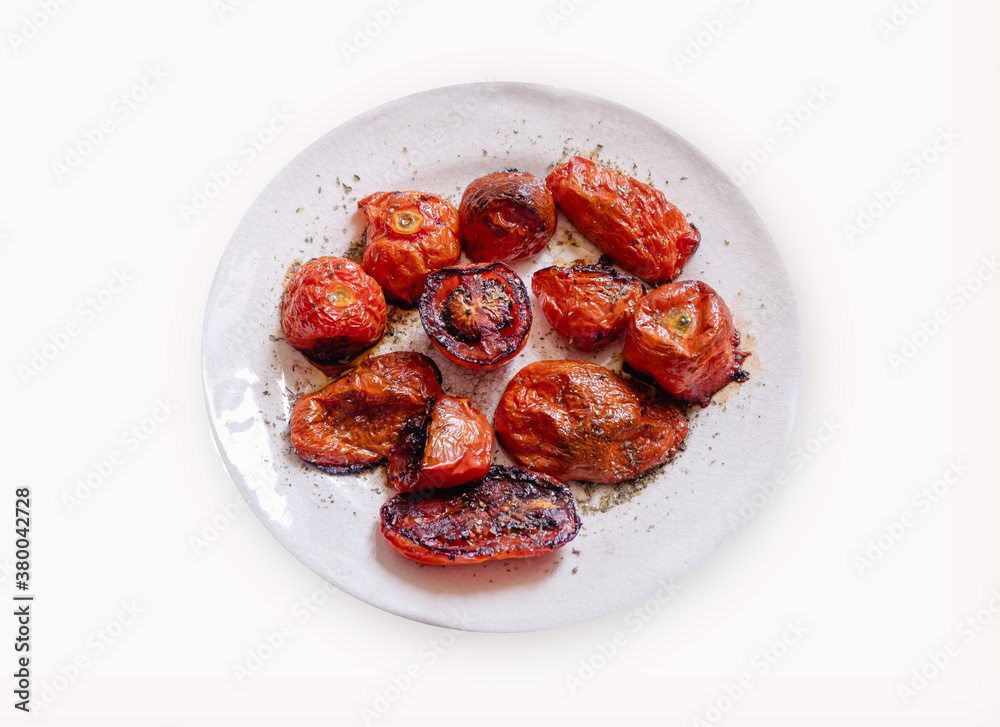 Old porcelain plate with roasted tomatoes isolated on white background. Old porcelain plate with roasted tomatoes isolated on white background.